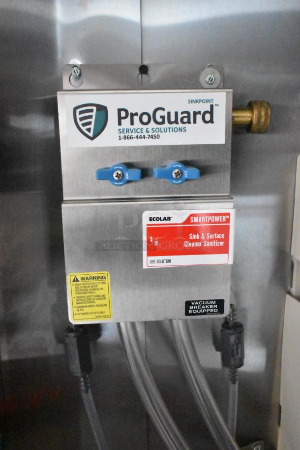 ProGuard sanitizer unit in 2020 ATX 8.5' x 24' food trailer, features dual controls, safety warnings, and vacuum breaker label.