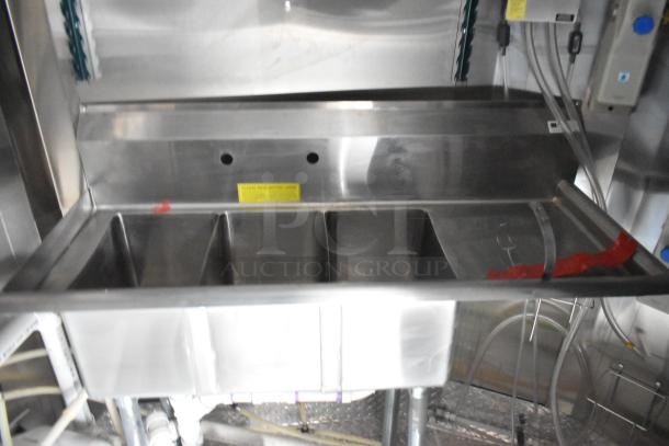 Stainless steel multitub sink inside a 2020 ATX food trailer, showing plumbing connections and cleanliness.
