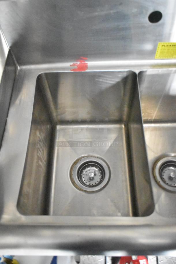Stainless steel sink inside 2020 ATX food trailer, featuring a CaptiveAire grease hood and Arctic Air equipment.