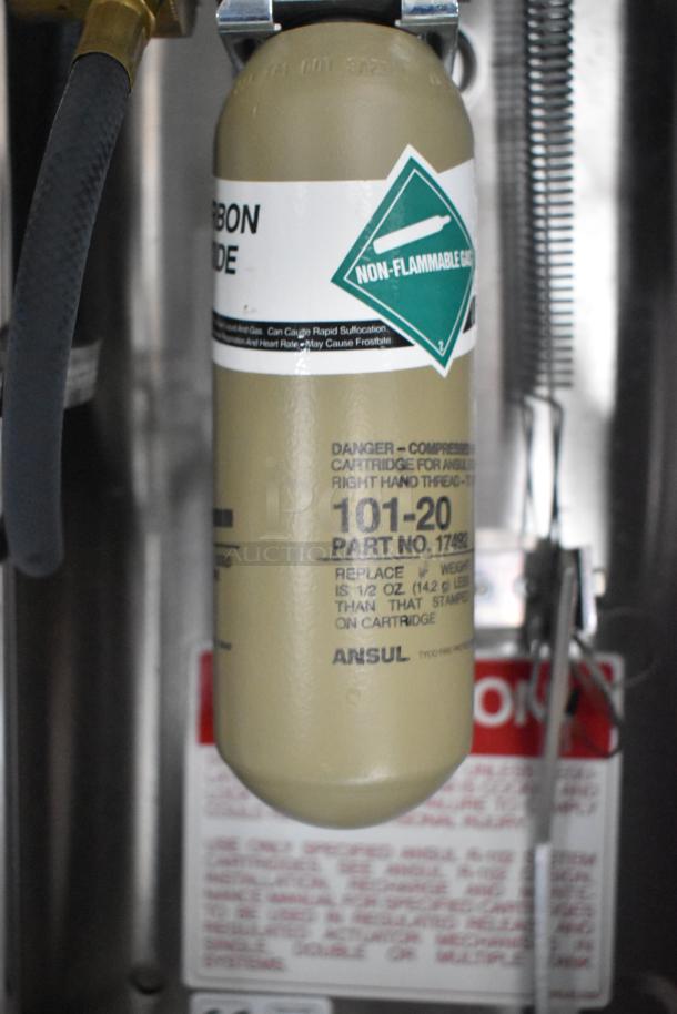 Ansul fire suppression canister labeled "Non-Flammable Gas" with model 101-20, part no. 17492, in cold food trailer.