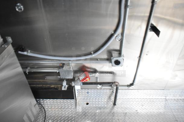 Interior view of a 2020 ATX food trailer showing electrical outlets and utility connections on a metal floor and wall surface.