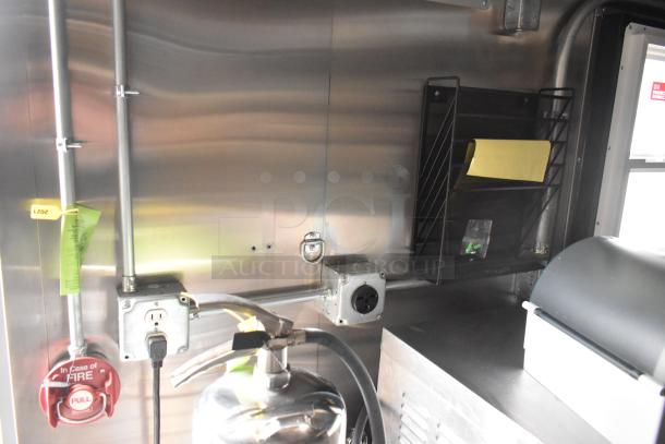 2020 ATX 8.5' x 24' trailer interior with electrical outlets, fire suppression system, and storage rack.