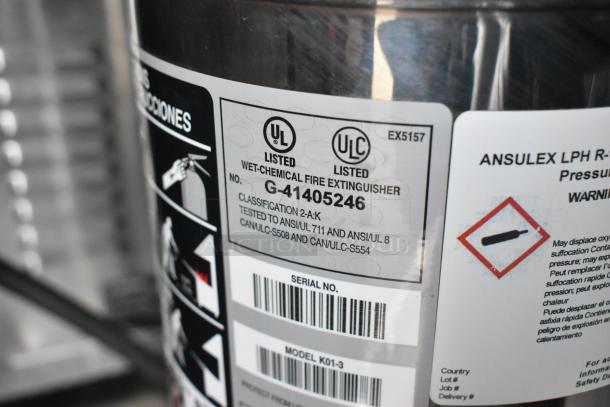 Wet-chemical fire extinguisher label with UL listings, serial number, and model K01-3 details, featured on a trailer.