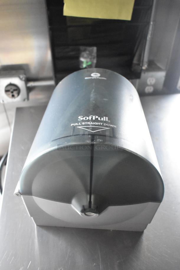 SofPull paper towel dispenser mounted on a stainless steel surface inside the ATX food trailer.