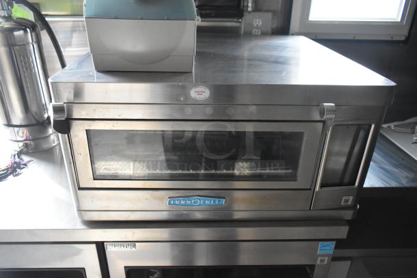 TurboChef oven inside a 2020 ATX food trailer, with stainless steel surfaces and caution label.