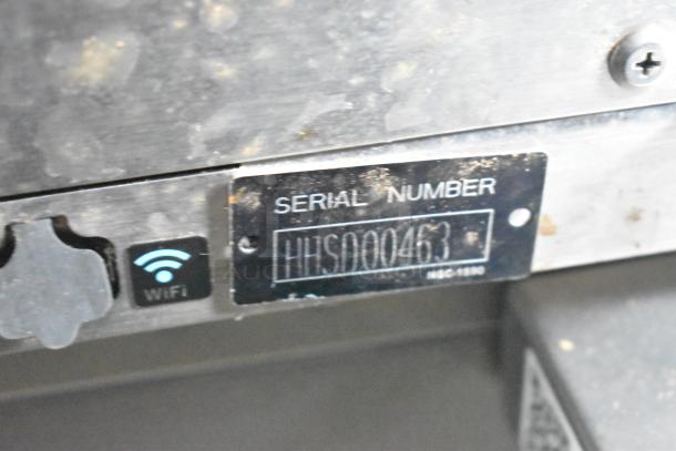 Serial number HHS000463 on metal plate, next to WiFi icon, on 2020 ATX food trailer equipment.