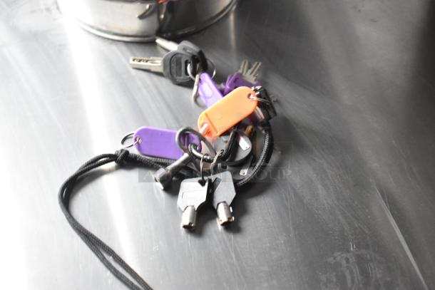 Keys with colorful tags are displayed on a metal surface, likely related to the 2020 ATX food trailer.