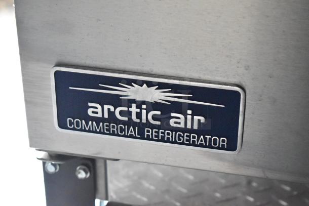 Arctic Air commercial refrigerator label on stainless steel surface.