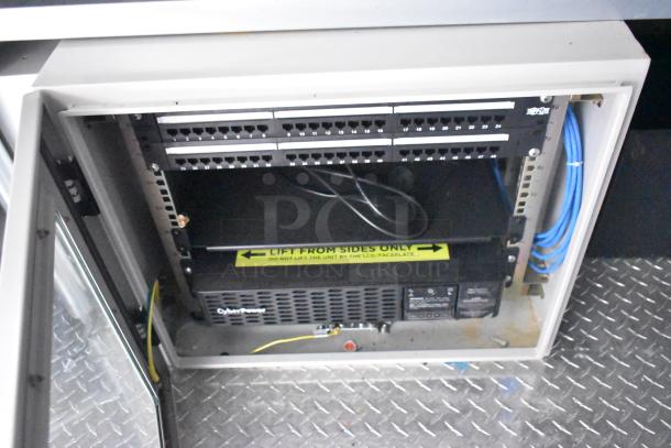 2020 ATX food trailer Martin IT cabinet with network switches, labeled "Lift from sides only," on diamond plate floor.