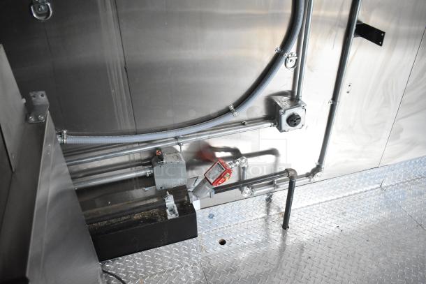 Electrical panel and piping inside a 2020 ATX 8.5' x 24' food trailer, featuring a diamond plate floor and metal walls.