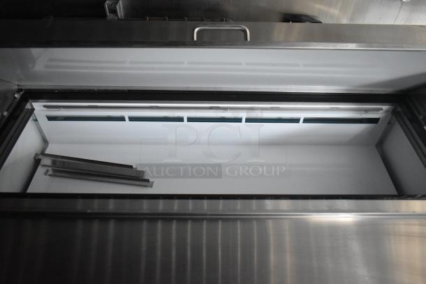 2020 ATX 8.5' x 24' food trailer interior with Arctic Air refrigeration unit. Features stainless steel surfaces.