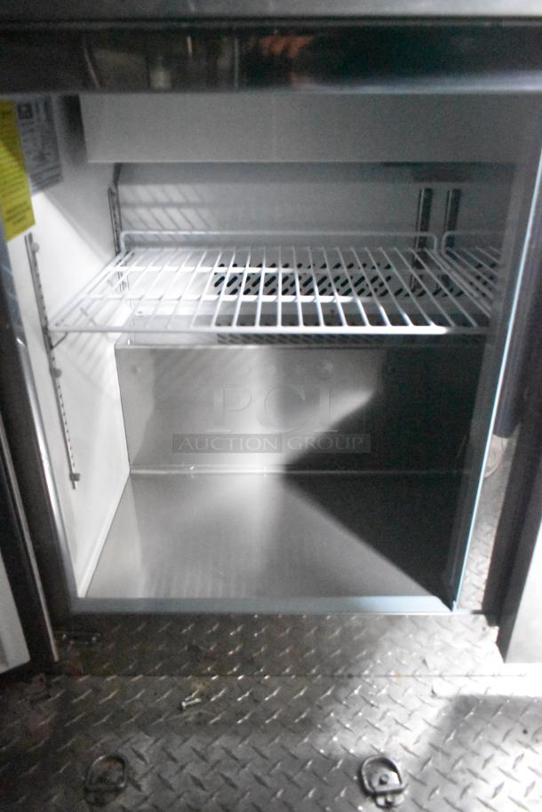 2020 ATX 8.5' x 24' food trailer interior showing Arctic Air cooler with wire shelf. Steel floor visible, clean condition.