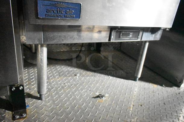 2020 ATX 8.5' x 24' food trailer interior showing Arctic Air commercial freezer on metal flooring.