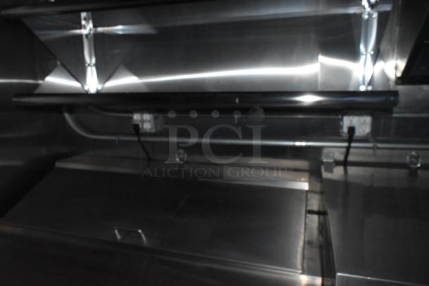 2020 ATX 8.5' x 24' trailer interior, featuring CaptiveAire grease hood. Stainless steel surfaces, outlets visible.