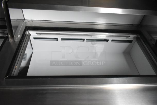 Interior view of ATX food trailer showing clean, stainless steel Arctic Air prep table.