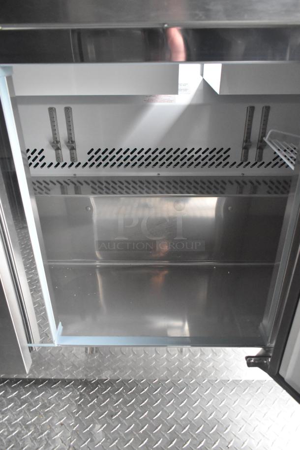 ATX 2020 8.5' x 24' food trailer interior showing refrigeration unit; stainless steel finish; diamond plate floor.