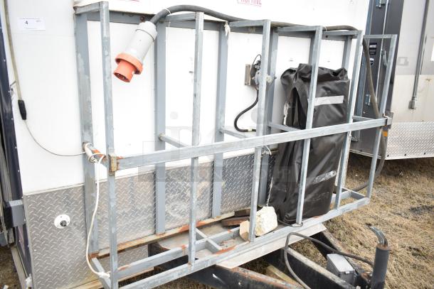 2019 Cruising Kitchens trailer section with exterior metal frame, electrical connections, and diamond plate siding, in used condition.