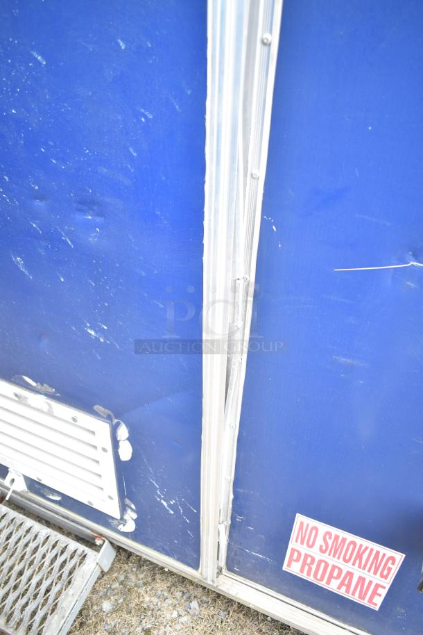 2019 Cruising Kitchens 8.5' x 24' trailer, blue exterior with wear, "No Smoking Propane" sign, vent, single axle.