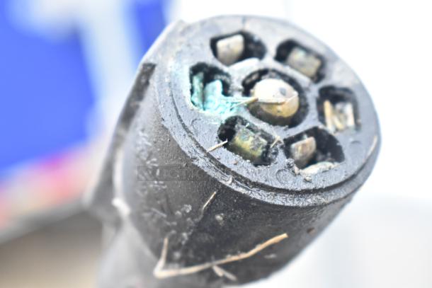 Close-up of a connector on a 2019 Cruising Kitchens trailer, showing wear. Features include grease hood and Arctic Air coolers.