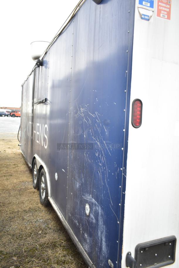 2019 Cruising Kitchens 8.5' x 24' trailer with visible wear. Features grease hood, fire suppression, Arctic Air equipment.