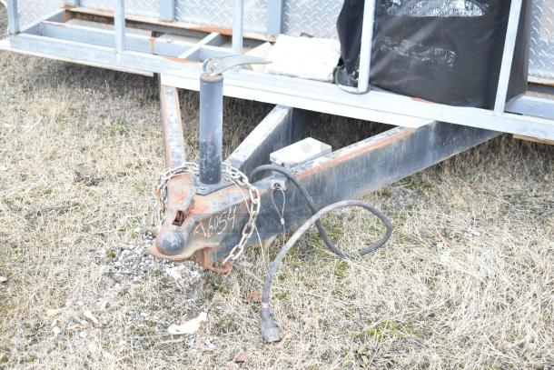 Rusty trailer hitch of a 2019 Cruising Kitchens food trailer. Chains and a cable are attached. Serial number: 46054.