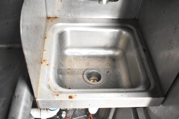Stainless steel sink in 2019 Cruising Kitchens trailer, showing signs of use with minor rust and wear.