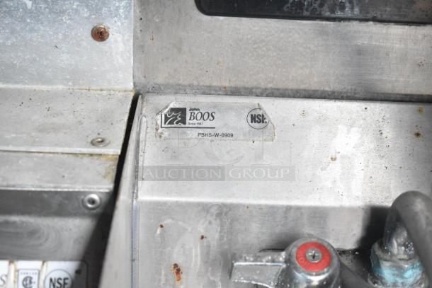 Metal surface showing a John Boos label, model PBHS-W-0909, with visible wear and rust around screws.