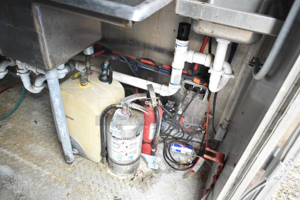 2019 Cruising Kitchens trailer interior showing plumbing, fire suppression system, and electrical components; single axle design.