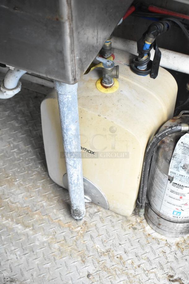 2019 Cruising Kitchens trailer interior showing a water tank and fire extinguisher on a metal floor.