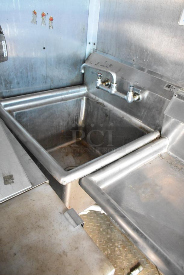 2019 Cruising Kitchens trailer interior showing stainless steel sink. Visible wear. Includes CaptiveAire grease hood.