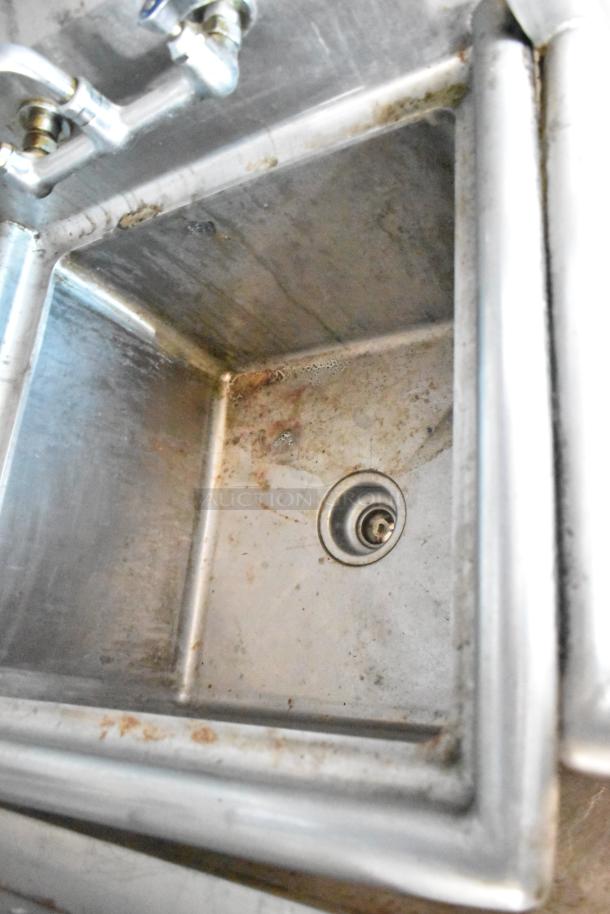 Stainless steel sink inside 2019 Cruising Kitchens trailer with visible wear and drainage hole.