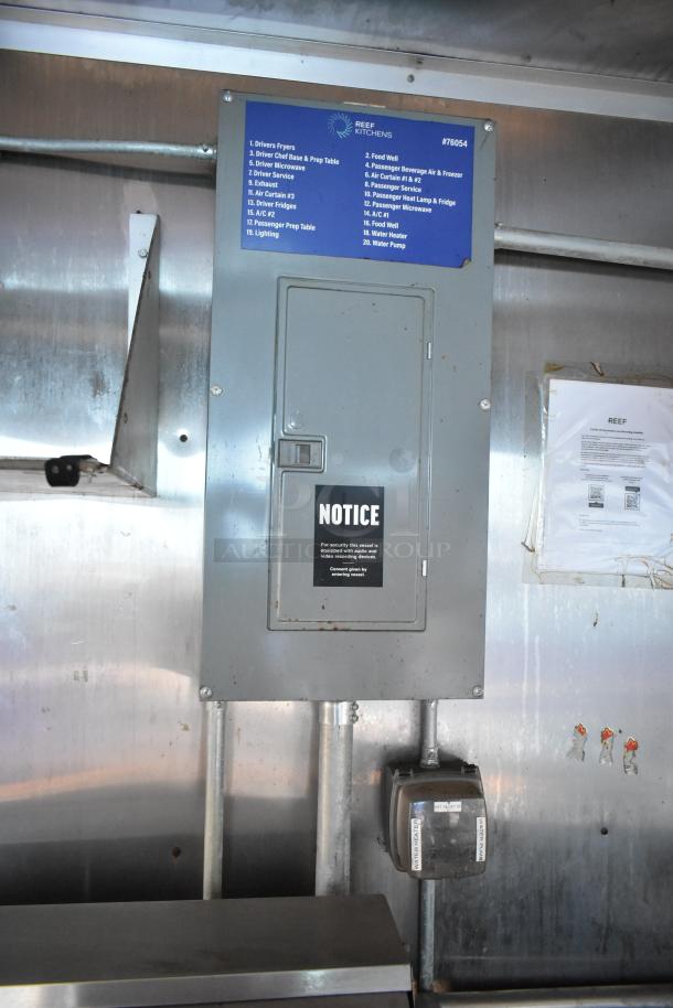 Electrical panel inside 2019 Cruising Kitchens trailer with notice and labeled switches; part of kitchen equipment setup.