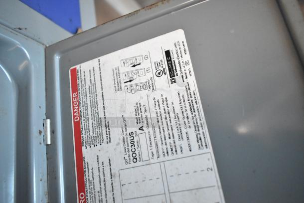 Label on metal interior featuring safety instructions and electrical specifications for the Cruising Kitchens trailer.
