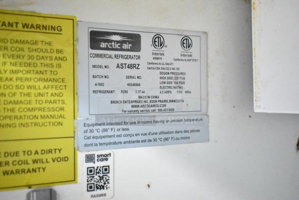 Arctic Air commercial refrigerator label showing model AST48RZ, refrigerant R290, and operational warnings.