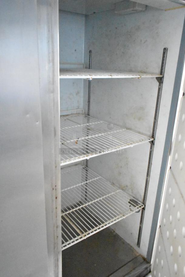Interior view of Arctic Air cooler with white wire shelves, showing mild wear. Part of 2019 Cruising Kitchens trailer.