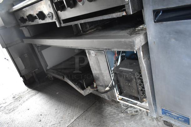 2019 Cruising Kitchens food trailer interior, featuring Arctic Air cooler, prep tables, and network cabinet, in used condition.