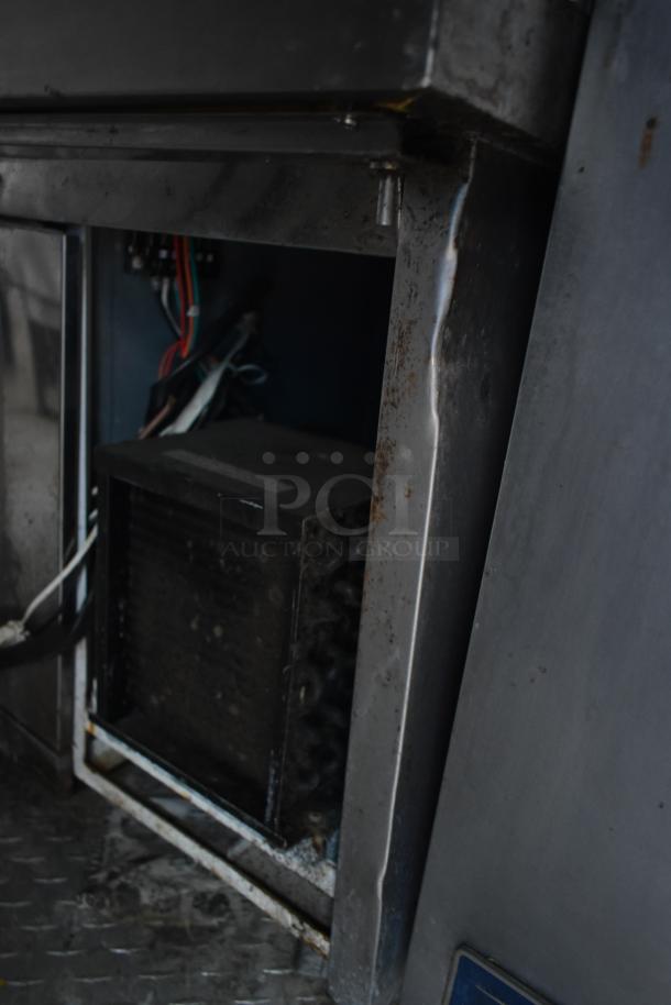 Inside view of a 2019 Cruising Kitchens cold food trailer showing the wiring and component space, indicating used condition.