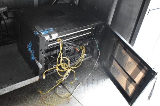 Martin IT/Network Cabinet inside 2019 Cruising Kitchens trailer. Features cables and venting, mild wear, with branding stickers.