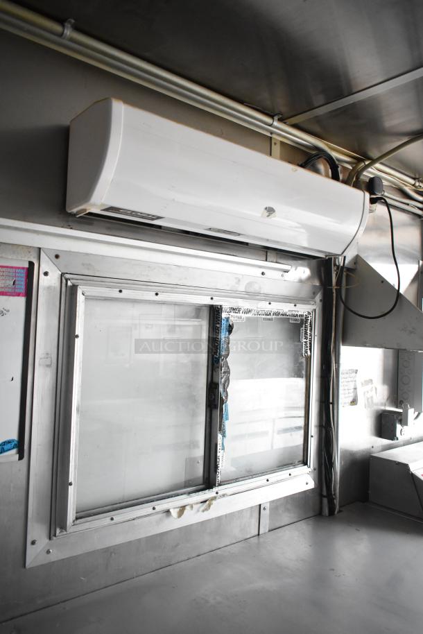 2019 Cruising Kitchens food trailer interior with window, Arctic Air unit, and stainless steel surfaces.
