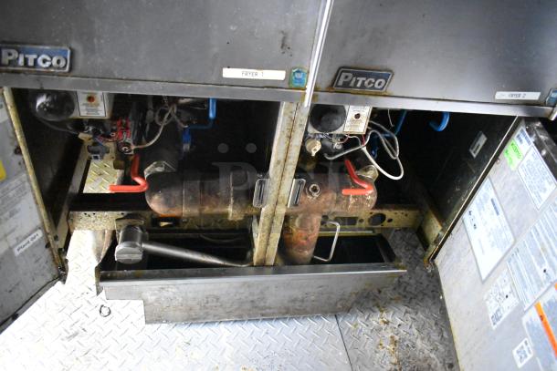 Interior view of a 2019 Cruising Kitchens cold food trailer showing Pitco fryers. Visible piping and wiring, fair condition.