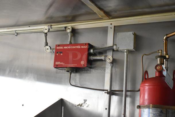 Fire suppression system inside 2019 Cruising Kitchens trailer, featuring a Model NMCH3 control head and visible piping.
