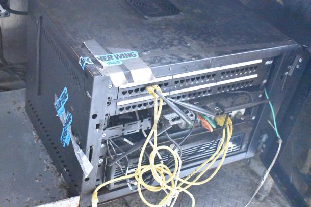 Martin IT/Network Cabinet with cables, as part of a 2019 Cruising Kitchens Food & Beverage Trailer, featuring CaptiveAire hood.