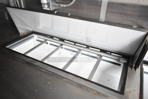 2019 Cruising Kitchens trailer interior, showing CaptiveAire grease hood detail with metal grates. Clean condition.