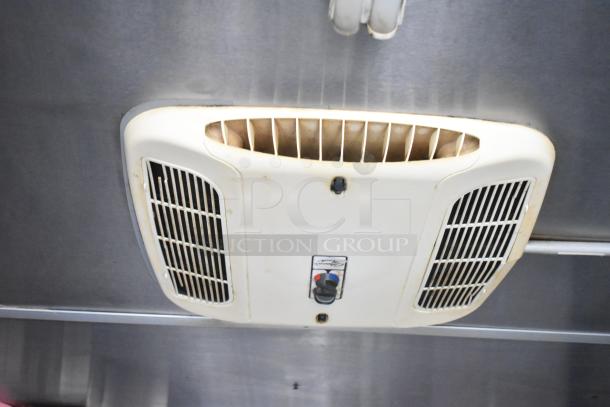 Interior of 2019 Cruising Kitchens trailer showing ceiling ventilation system, part of CaptiveAire grease hood setup.