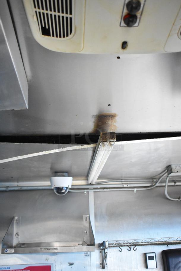 Interior of a 2019 Cruising Kitchens trailer showing CaptiveAire grease hood, Arctic Air units, and security system.