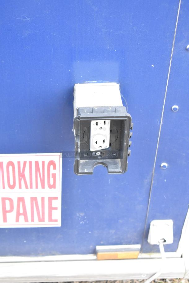 2019 Cruising Kitchens trailer exterior with open electrical outlet. "No Smoking" warning visible.