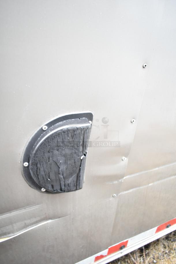 Damaged side panel of 2021 Nationwide 8.5' x 24' food trailer shell. Features a cracked vent cover. Sold with clear title.