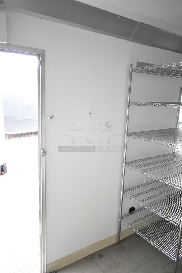 2021 Nationwide 8.5' x 24' food trailer shell, equipped with wire shelving units and space for additional fixtures.