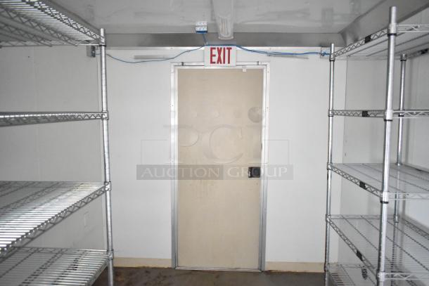 2021 Nationwide 8.5' x 24' food trailer shell interior, featuring wire shelving units and a Martin IT/Network cabinet, ready for customization.