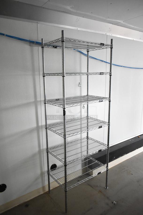 2021 Nationwide 8.5' x 24' food trailer shell interior with wire shelving units, sink setup, and Martin IT/Network cabinet.